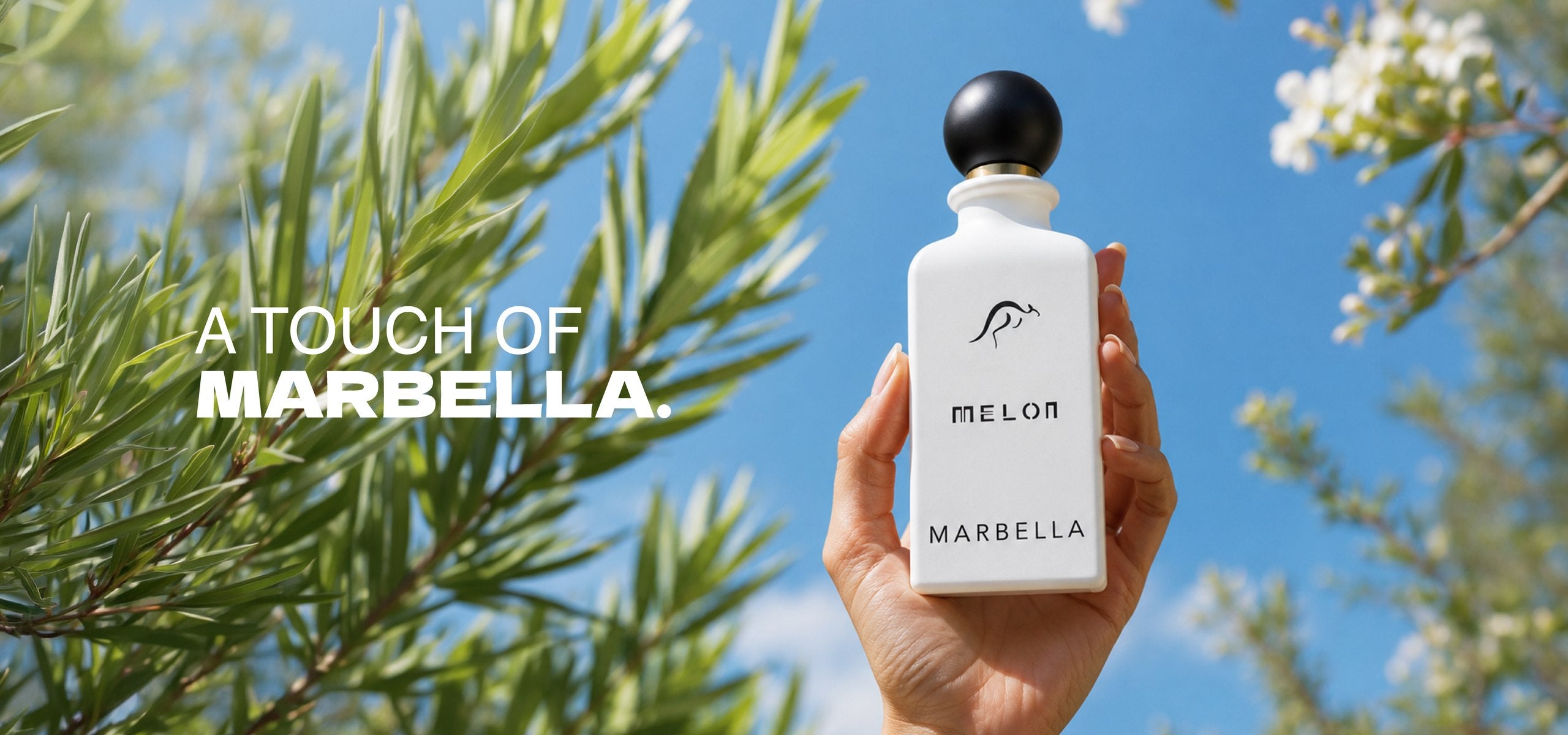 Melon Marbella fragrance held against olive branches. A touch of Marbella.